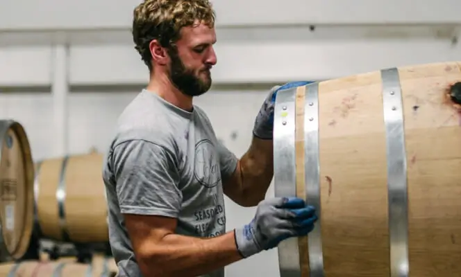 Man moving wine barrel