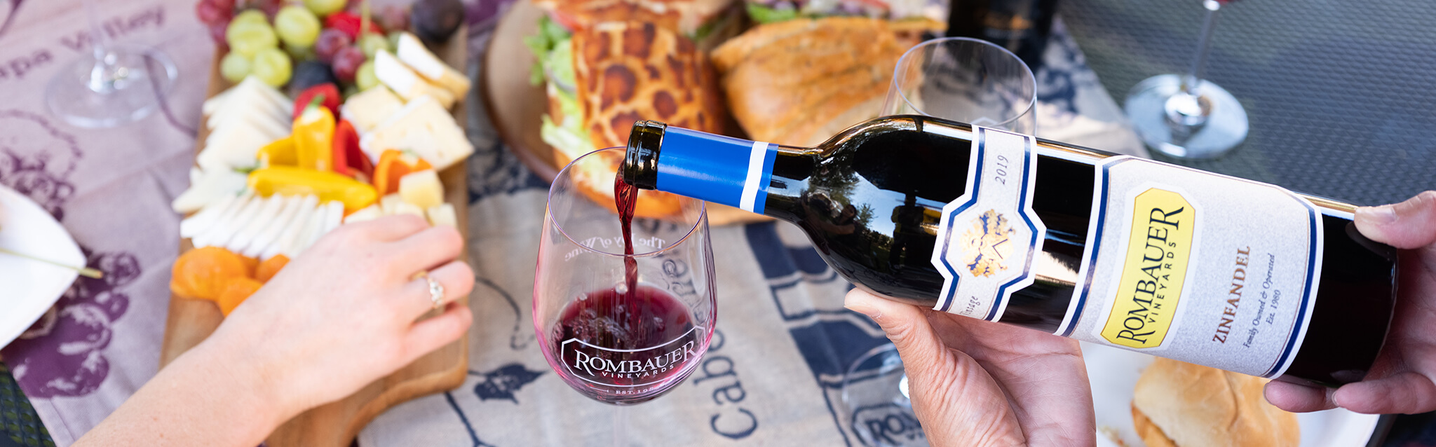 Zinfandel Pouring with Food Behind it