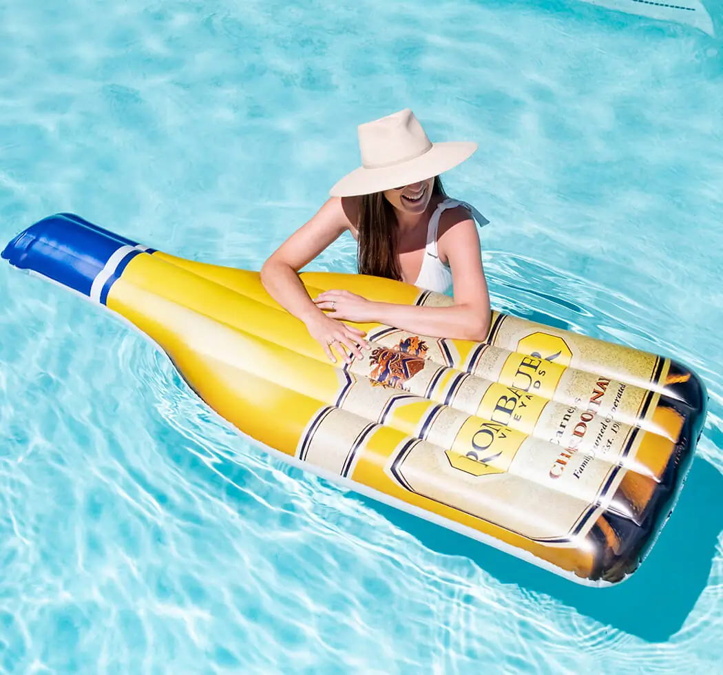 A woman with her arms on a Rombauer Chardonnay Pool Floatie