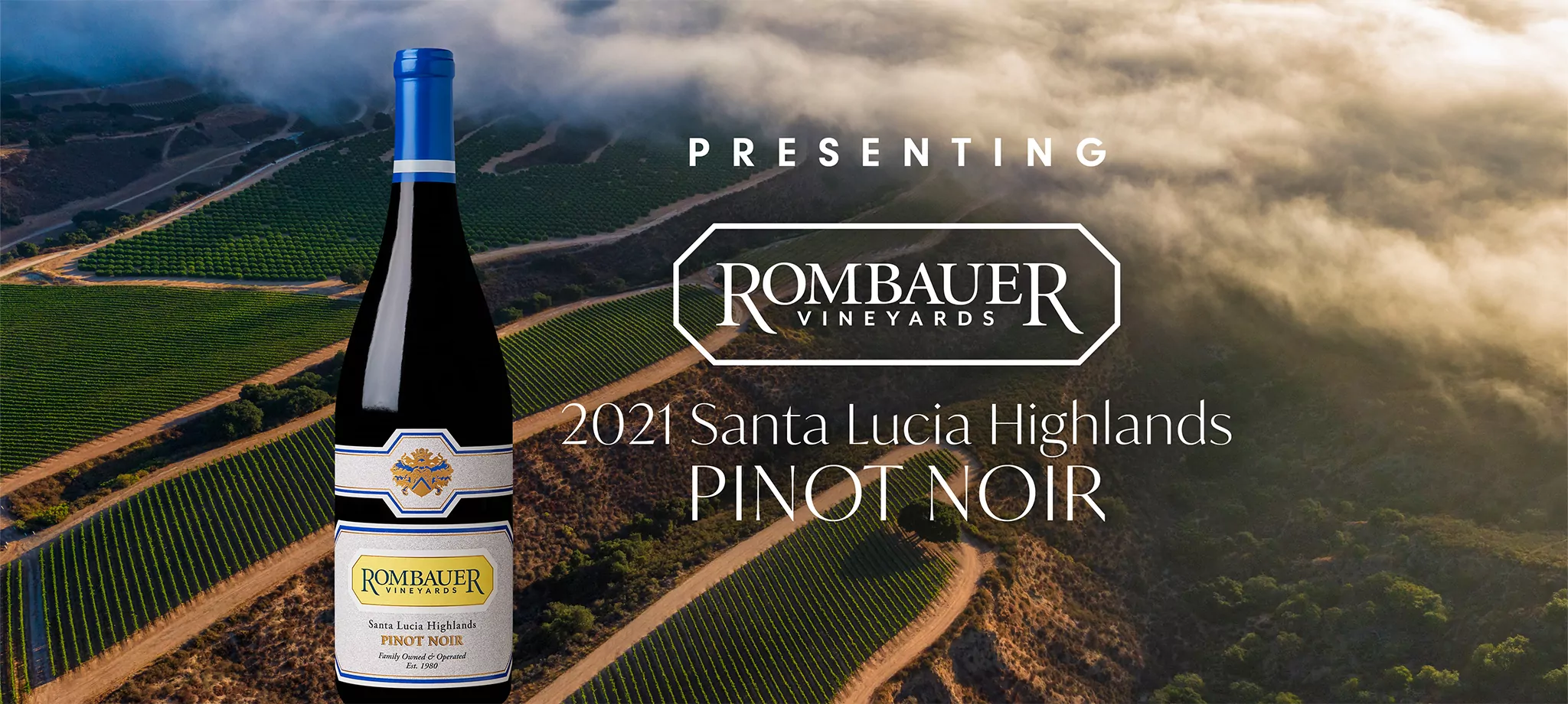 Rombauer Pinot Noir bottle in front of a beautiful Santa Lucia Highlands vineyard
