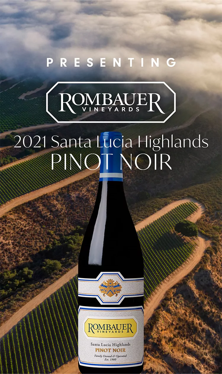 Rombauer Pinot Noir bottle in front of the Santa Lucia Highlands vineyards